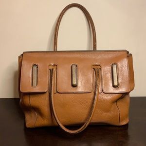 All leather sachet style purse. Pictures reflect the true rich med brown color.